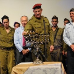 Chief of the General Staff Lt. Gen. Benny Gantz, flanked by President Shimon Peres (left) and IDF Chief Rabbi Brig. Gen. Rafi Peretz (right), lighting a menorah this week Read more: The IDF marches '. 2012. Web. 19 Dec. 2014.